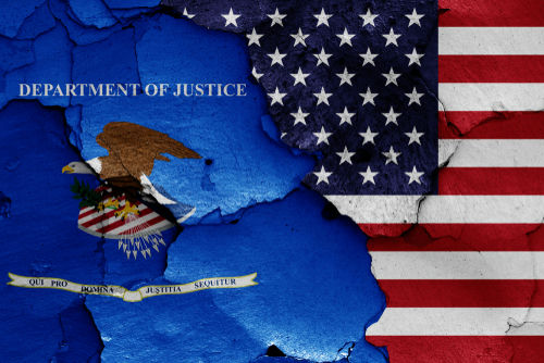 shutterstock1130570855-1jpg Flags of the US and Department of Justice, cracked background.