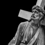 Easter Massacre Cover-Up — Christians Still CAPTIVE… A black and white statue of Christ carrying a cross with a sorrowful expression