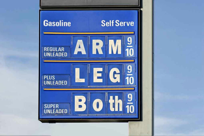 1719803 Gasoline price sign with humorous mode of payment.