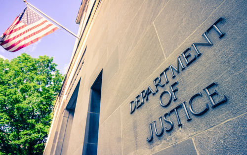 shutterstock1384089728-1jpg Department of Justice building with American flag.