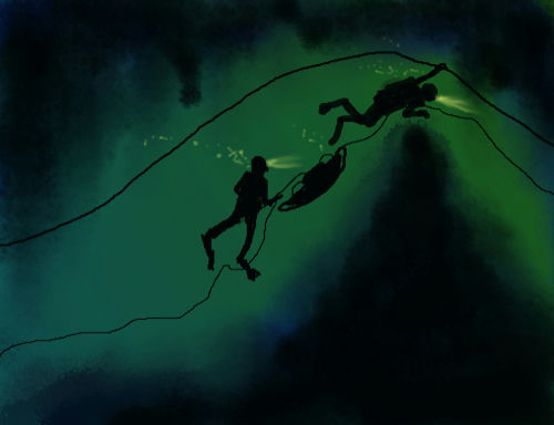 Two scuba divers follow a guideline through a dark underwater cave