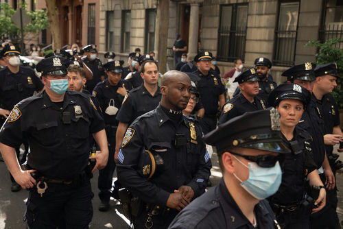 shutterstock1754871284jpg Police officers gathered on a city street