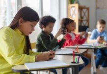 85,000 Kids Vanish — Who Lost Them? Students using smartphones at classroom desks