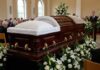 The Hidden Health Threat Behind Lindsey Graham’s Death A wooden casket surrounded by flowers at a funeral service