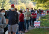 People in line for voting with Curbside Voting sign.