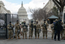 Soldiers standing guard in front of United States Capitol.