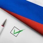 Russian flag, pen, and check mark on paper.