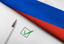 Russian flag, pen, and check mark on paper.