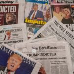 Newspapers with headlines about Donald Trumps indictment.