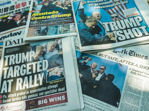 Newspaper headlines about an assassination attempt on Donald Trump.